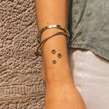 Tatuaje Trío de Huellas de Perro Negras